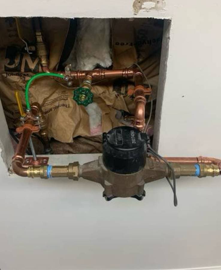 Gas shutoff valve and meter assembly connected to residential plumbing system