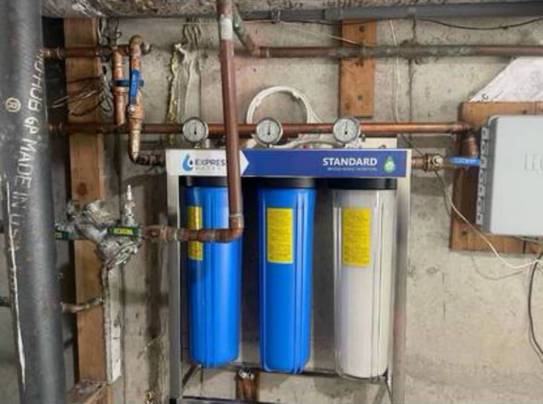 Water filtration and treatment system installed with multiple filters and pressure gauges